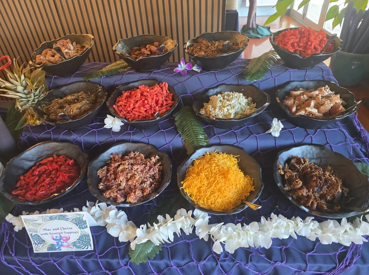 A catering spread with bowls of toppings and flower leis