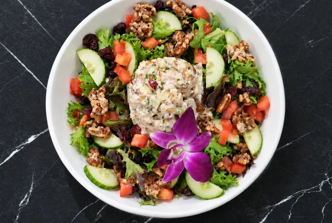 Chicken salad over mixed greens with walnuts and cranberries