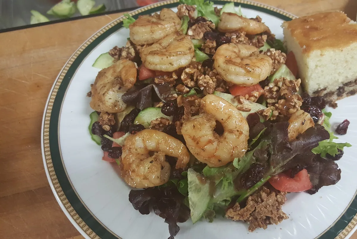 Grilled jumbo shrimp over mixed greens
