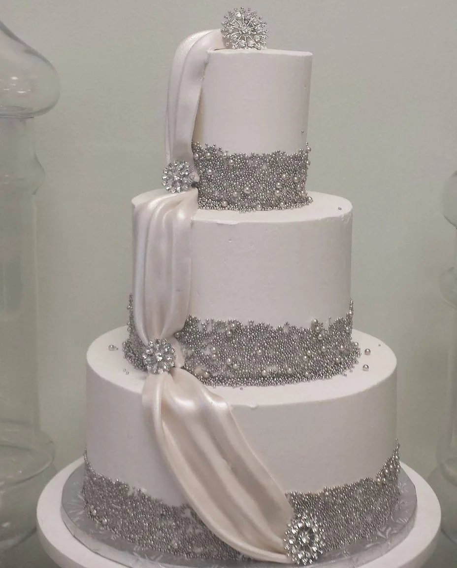 A three-tier wedding cake made by Aloha Bakery